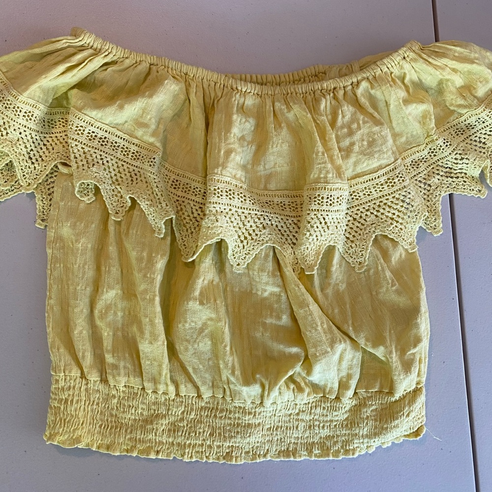 Yellow off the shoulder blouse.